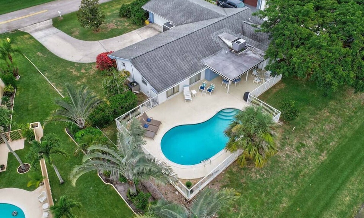 BallenIsles Apartment | Magnolia Tiki House! Waterfront Heated Salt Pool & Game Room!