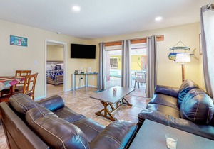 Canal-front condo with pool, boat slip, deck, central AC, & fast WiFi