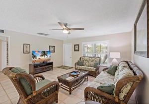 Cozy home with sunroom, pool and steps to beach