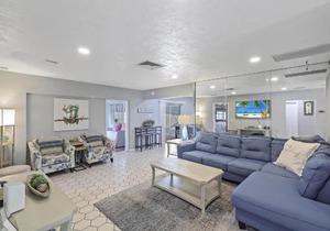 Home on water with pool/lanai kitchen/walk to beach