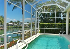 Modern waterfront house with heated pool and view of converging waterways