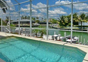 Modern waterfront house with heated pool and view of converging waterways