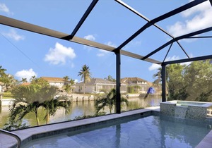 Picturesque waterfront home w/ heated pool, hot tub & outdoor kitchen