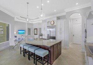 SW exposure home on wide canal with pool and spa