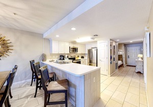 Updated 1st-floor condo with large private balcony, pool, grills, firepit, & gym