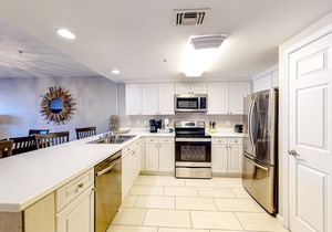 Updated 1st-floor condo with large private balcony, pool, grills, firepit, & gym