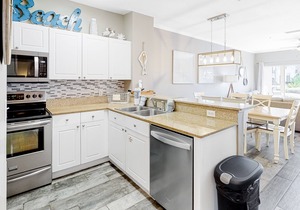 Updated, beachside condo with dual suites, balcony & pool - walkable locale