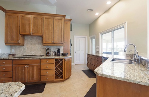 Beachview Country Club Estates House | Exquisite river-view home with heated pool and spa in the expansive lanai