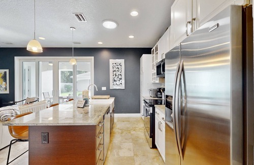 New Smyrna Beach House | Manicured home & pool house w/private pool - short walk to the ocean