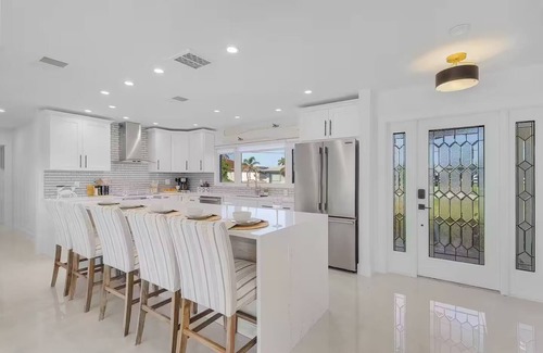Yacht Club House | Renovated 3-bed, 2-bath home with pool, dock, bar, patio, and waterfront access.