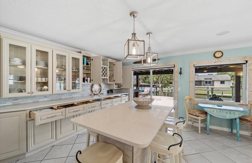 Palm Harbor House | Waterfront Retreat with Pool, Tiki Bar & Boat Dock