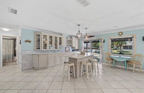 Palm Harbor House | Waterfront Retreat with Pool, Tiki Bar & Boat Dock