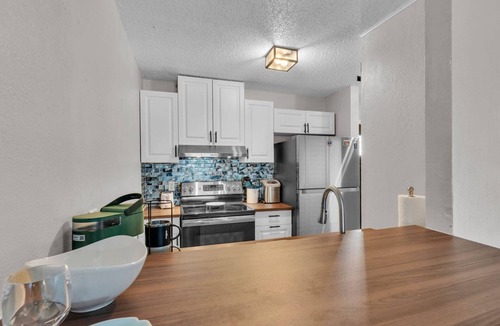 Winter Haven Condo | 2BR Waterfront Condo w/Pool access, Dock, Patio Views & 3 Miles from LEGOLAND