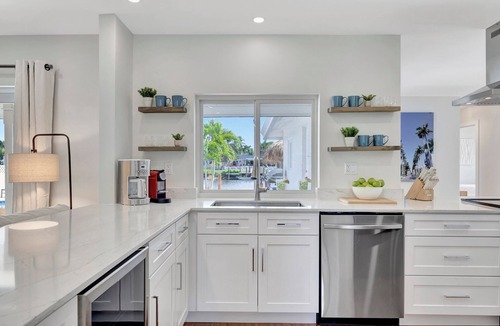 Tropic Palms House | 796 Serene 4BR Villa: Heated Pool, Tiki Hut & Waterfront Views in Delray Beach!