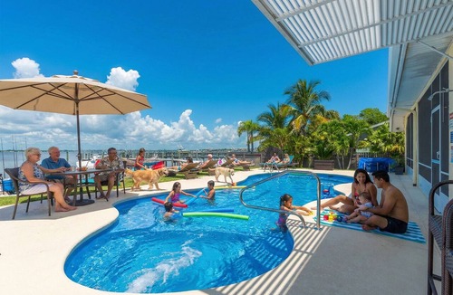 Stuart House | Aquatopia South: Riverfront Beach House, Steps 2 Ocean. Heated Pool & Dock!
