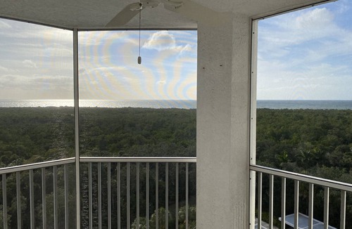 Pelican Bay Condo | Beautiful sunset views of the Gulf from this western facing 9th floor condo.