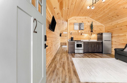 Hartwell RV Rental | Cabin #2: One king-size bed with a full kitchen for cooking and a large gravel parking pad beside the cabin for easy boat trailer storage.
