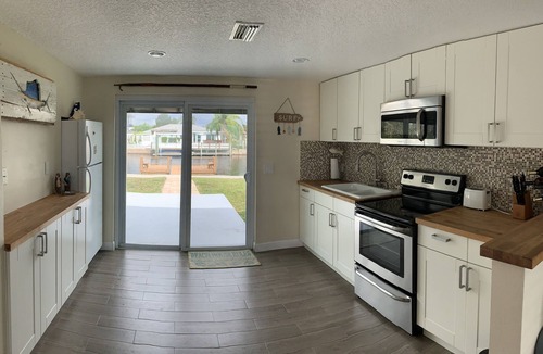 Hudson Beach Estates House | Canal front home walking distance to restaurants and small beach