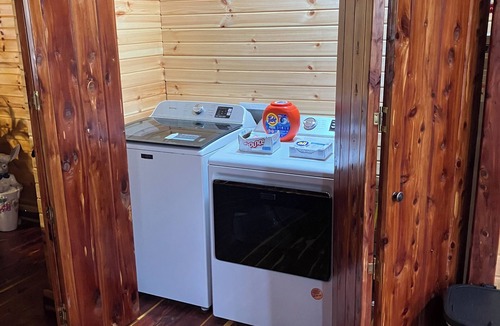 Saffell Cabin | Cedar log cabin overlooking spring-fed ponds with waterfalls at Wautauga Springs