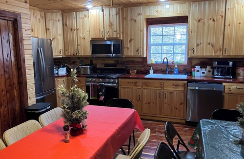 Saffell Cabin | Cedar log cabin overlooking spring-fed ponds with waterfalls at Wautauga Springs
