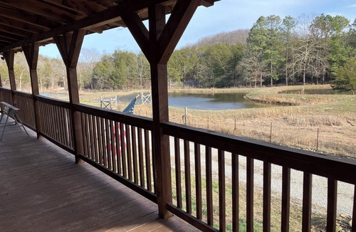 Saffell Cabin | Cedar log cabin overlooking spring-fed ponds with waterfalls at Wautauga Springs