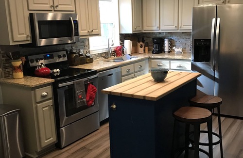 Hillsborough House | Charming brick ranch with spacious fenced yard.
