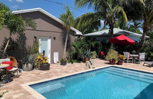 Parrot Cove Cottage | Chill on the patio overlooking the pool & lush gardens with privacy!
