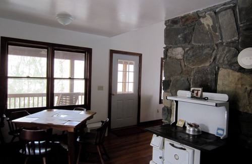 Plumtree Cabin | Classic mountain cabin with beautiful stone fireplace in a rural setting