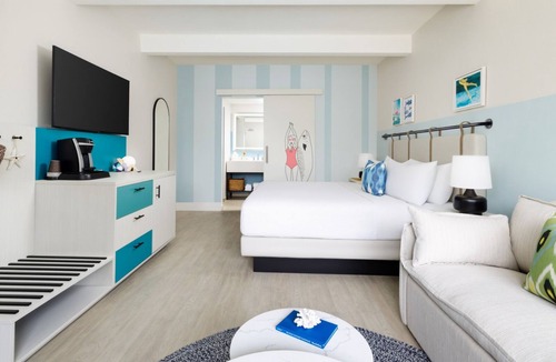New Town Hotel | Colorful Stay at Blue Flamingo | Poolside Bar, Lawn Games, Music & Fire Pits
