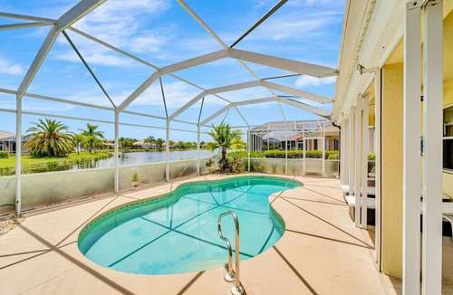 Herons Glen House | Country club retreat with private pool, water views, on-site golf, & gym