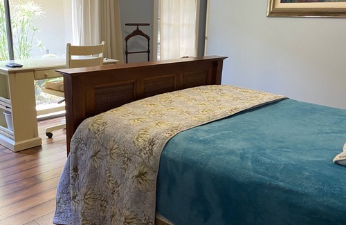 Hunt Club Bed & Breakfast | Country Garden Room with Water Garden feature and Queen Bed.