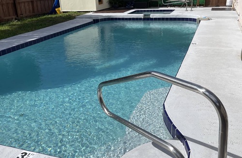 Lake Worth Apartment | Cozy room with pool and patio.