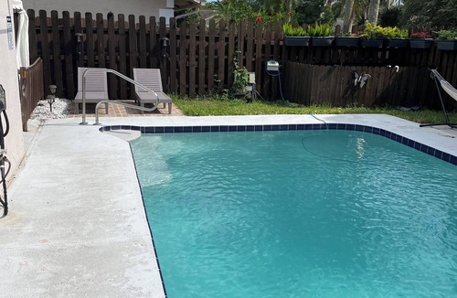 Lake Worth Apartment | Cozy room with pool and patio.