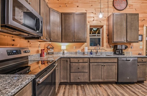Sevierville Cabin | Creekside 2BR cabin near Pigeon Forge with firepit, WiFi, EV charger, and pet-friendly charm.