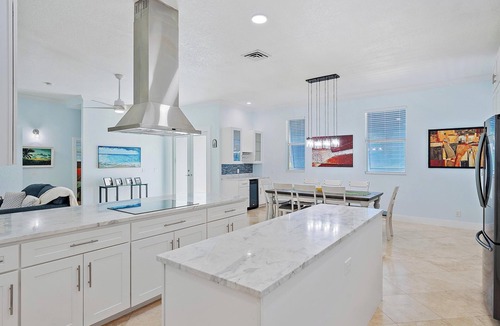 Palm City House | Deep water front home with private dock, pool, outdoor kitchen and pool table.