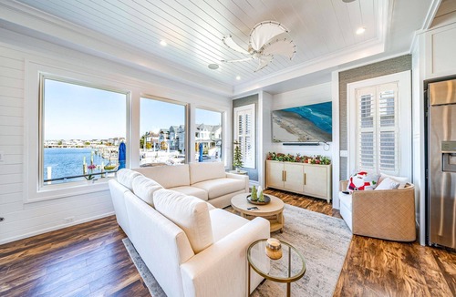 Stone Harbor House | Discover an extraordinary waterfront haven with this magnificent bayfront residence that boasts a.