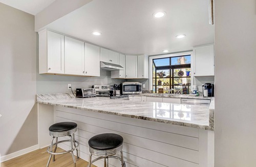 Ocean Ridge Condo | Dog-friendly beach home with screened porch, charming interior, & W/D