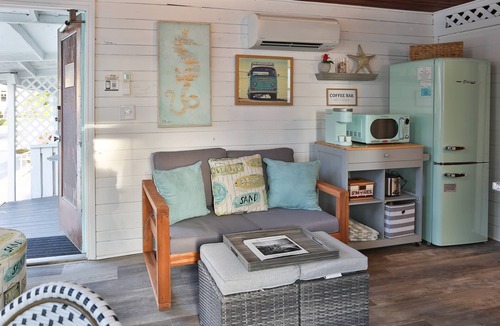Treasure Island Condo | Fresh vintage beach vibes! Happy day getaway w/beachfront access, community fire pit & lounge area.