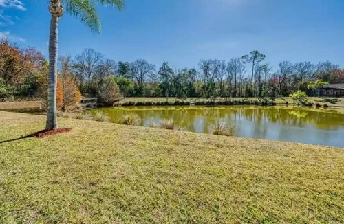 Lake Wilson Preserve House | Gorgeous water view from South facing pool deck. Balcony off upstairs master bed