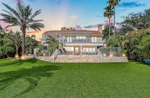 Carrollwood House | Inviting lakefront home with dock, kayaks, hot tub, pool, firepit, & W/D