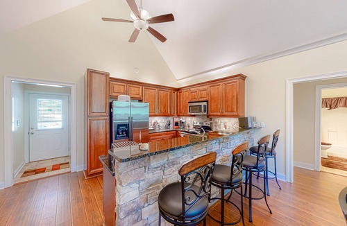 Sparta House | Inviting waterfront home with fireplace, dock, patio, central AC, & W/D