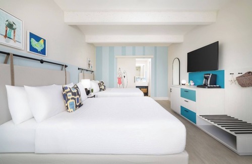 New Town Hotel | Laid-Back Luxe | Pools, Comfort Foods, Lawn Games & Shuttle to Fun