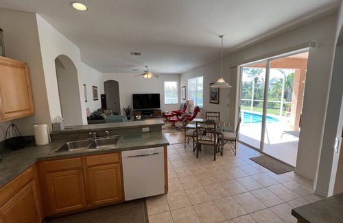 Beachwalk Isles House | Lakefront one-level home with pool, screened lanai & W/D - snowbird-friendly