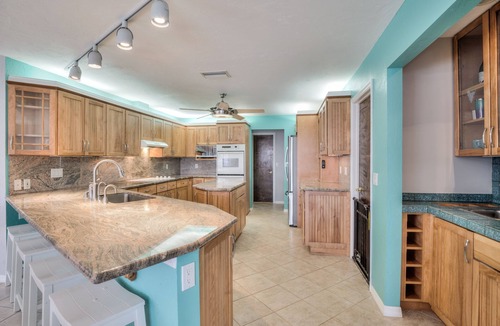 Yacht Club House | Lovely Canal Home in SW Cape with heated pool, game room, and a tiki on the dock
