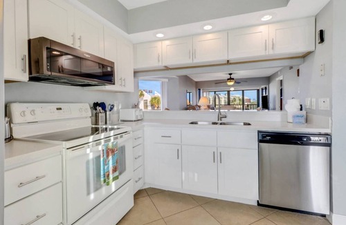 Mid Island Condo | Lovely End-Unit, Lagoon-Front Community, South of Mid-Island! Heated Community Pool! Free Parking!