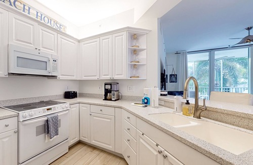 Vanderbilt Beach Condo | Luxurious condo with on-site pool, private extended balcony, & W/D