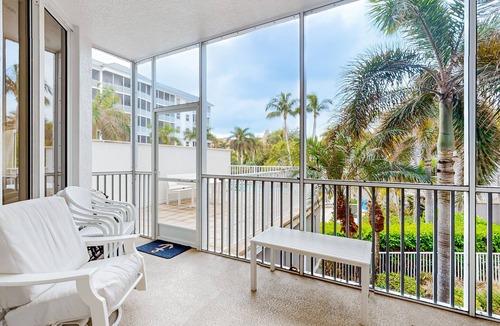 Vanderbilt Beach Condo | Luxurious condo with on-site pool, private extended balcony, & W/D