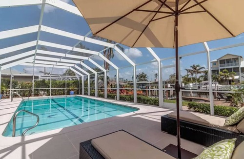 Isles of Capri House | Luxurious Waterfront Retreat! Oversized Heated Pool and expansive outdoor area!