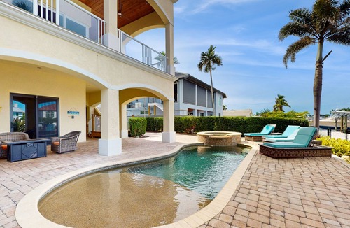 Siesta Isle House | Luxury home boasting waterfront views with pool and golf simulator