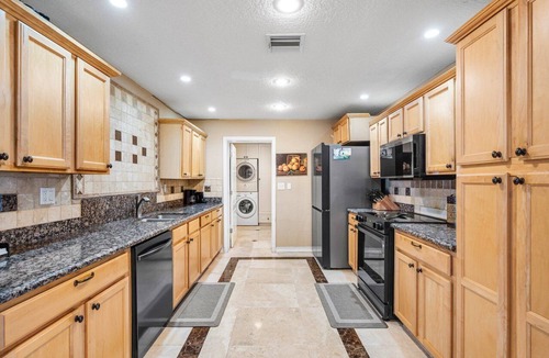 Lake Worth House | Luxury Lakefront Retreat with Heated Pool, Tiki Lounge, Dock, Gym & EV Charger
